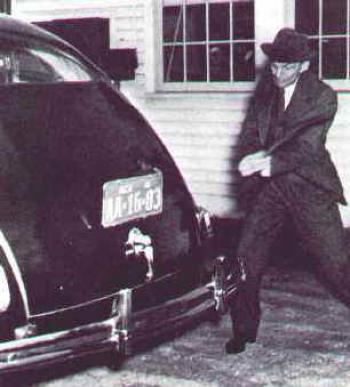 Henry Ford hits the soy plastic car body of his soy car with an axe