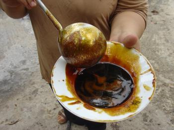 Saosan making carob syrup in Ayn Hawd, Debra Solomon, culiblog.org