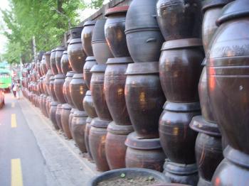 Kimchi pots stored along the side of a busy road, from Jwh8a's photostream on Flickr, Debra Solomon, culiblog.org