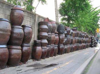 Kimchi pots stored along the side of a busy road, from AtDawnWeRide's photostream on Flickr, Debra Solomon, culiblog.org